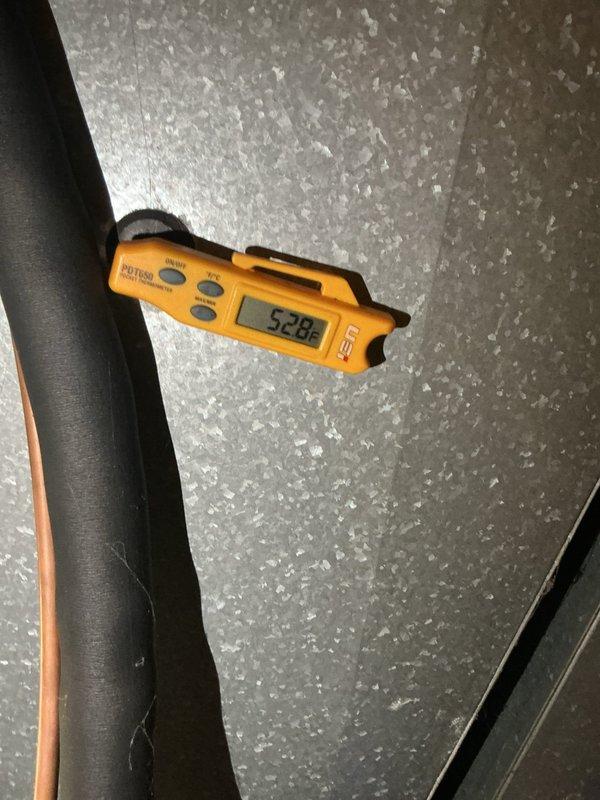 Completed preventative maintenance on residential cooling system. Verified supply air temperature at 52.88°F indicating proper cooling operation. Tested electrical components using clamp meter, confirming voltage at 244V and amperage at 27.9A within normal operating parameters for the unit.