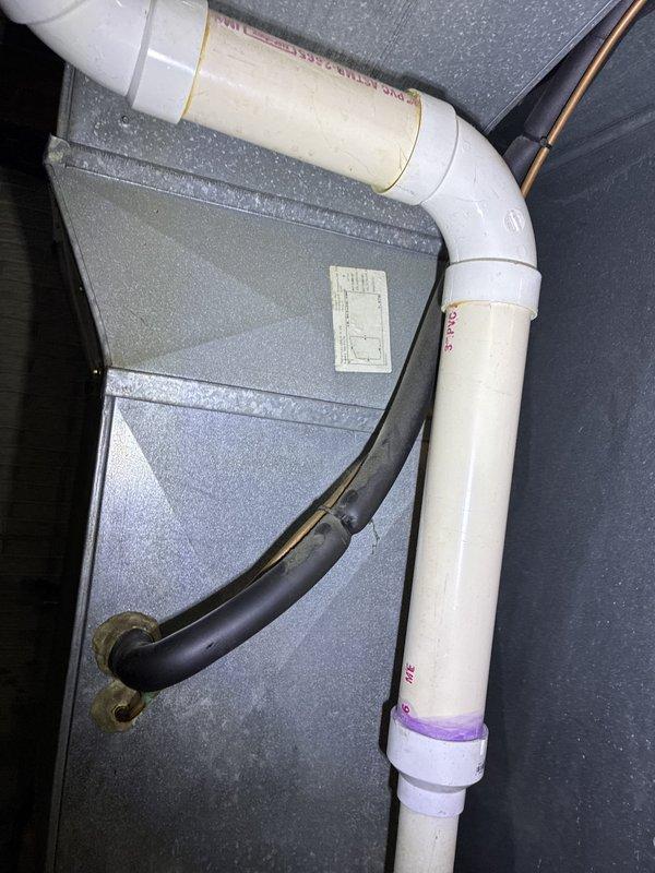 Responded to no cooling complaint on late 1990s HVAC system located in basement mechanical space. Upon arrival, inspected existing vertical air handler unit with associated ductwork, refrigerant lines, and PVC condensate piping showing signs of age and deterioration. Evaluated complete system including exposed copper refrigerant lines, electrical connections, and aged control panel mounted on equipment. Provided customer with replacement options for full HVAC system due to equipment age and lack of cooling functionality.