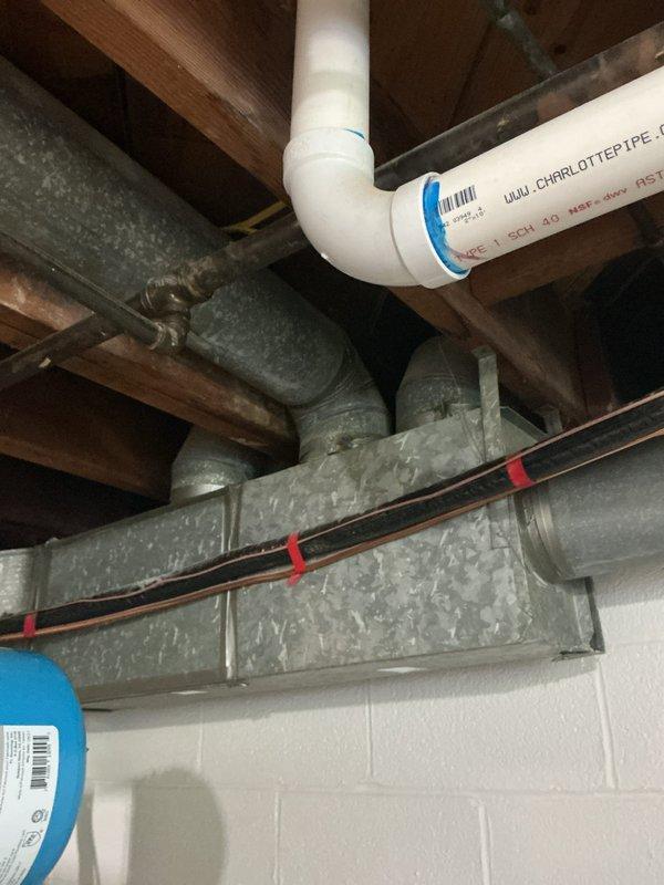 Responded to no cooling complaint for upper zone air conditioning system. Upon arrival, performed diagnostic inspection of HVAC equipment and ductwork in mechanical space. Visually inspected PVC condensate drain lines, supply/return ductwork, and refrigerant lines for obvious issues. Documented existing conditions of mechanical systems including galvanized ductwork, copper refrigerant lines, and drainage components. Further diagnostics required to determine root cause of cooling deficiency in upper zone.