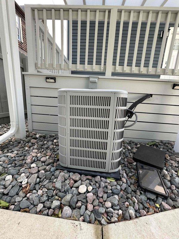 Completed routine cooling maintenance on residential heat pump system. Inspected outdoor condensing unit, electrical disconnect, and all accessible components. Verified proper operation of unit mounted on vibration-dampening pad with adequate clearance from building structure. Confirmed electrical connections at disconnect box secure, refrigerant lines intact, and unit operating within normal parameters for seasonal cooling performance.