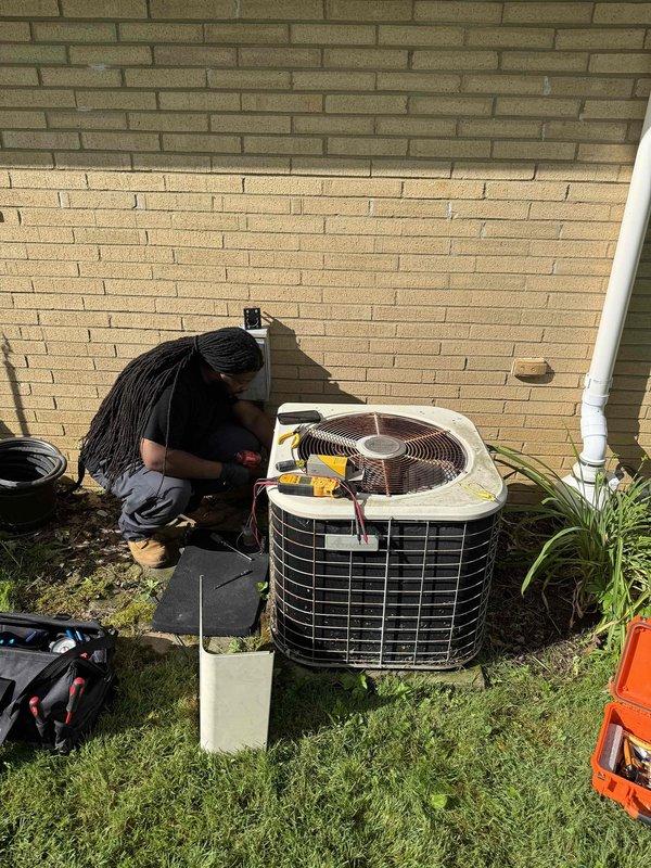 Performed comprehensive cooling system maintenance on residential air conditioning unit. Conducted thorough inspection of outdoor condenser unit, including examination of refrigerant lines with yellow insulation for proper installation and wear. Assessed condenser coil condition, checked electrical connections, and verified proper unit operation. Inspected condensate drainage system including flexible conduit and discharge line to ensure proper water removal and prevent blockage. Cleared debris and vegetation from around unit base and condensate drain area to maintain adequate airflow and prevent drainage issues. Verified all mechanical and electrical components functioning within normal parameters. System operating efficiently with no immediate repairs required.