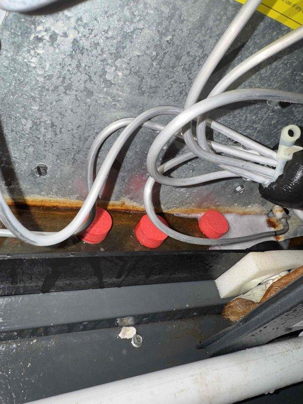 Replaced failed fan motor and blade assembly on HVAC unit to restore proper airflow and system operation. Performed thorough coil wash to remove accumulated debris and improve heat transfer efficiency. Installed drain tabs to prevent future corrosion and maintain proper condensate drainage, addressing the significant rust buildup observed on internal components.