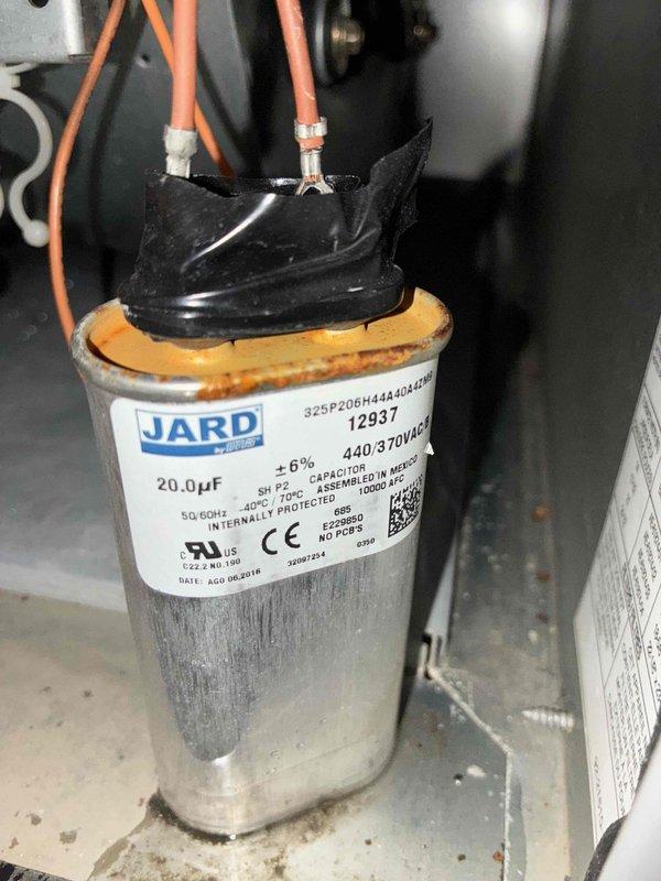 Performed scheduled cooling system maintenance visit. Upon inspection, discovered failed capacitor with visible physical damage including ruptured casing and corrosion at terminal connections. Replaced defective 20.0µF 440/370VAC dual run capacitor with new unit. Verified system temperatures using calibrated infrared thermometer, confirming proper operational parameters post-repair. System restored to full functionality and tested for proper cooling cycle operation.