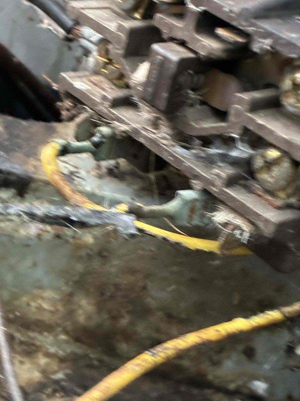 Completed afternoon cooling system tune-up on non-member residential HVAC unit. Upon inspection, found extensive debris accumulation including decomposed leaves, dirt, and organic material around outdoor condenser unit's electrical junction box and wiring connections, creating potential fire hazard and impeding proper system operation. Observed visible corrosion on electrical components and wire connectors due to moisture exposure and debris buildup. Cleaned electrical connection area, removed accumulated organic material from junction box, and inspected all wiring for damage. Verified capacitor function and compressor operation. Unit returned to normal operating condition with improved airflow and electrical safety.