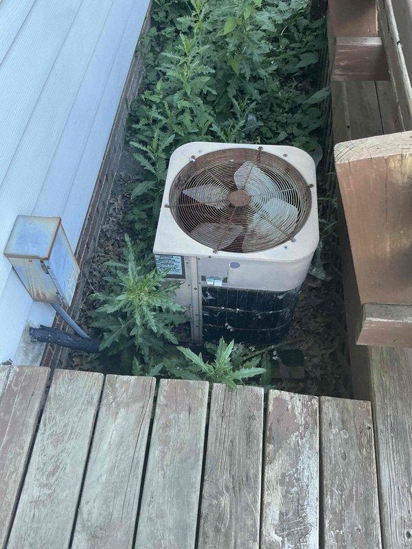 Conducted comprehensive evaluation of 20-year-old HVAC system for full replacement options. Assessed outdoor condenser unit showing significant age-related deterioration including corroded fan assembly components and documented existing equipment specifications and spatial constraints in narrow side yard installation area. Provided customer with complete system replacement recommendations based on current equipment condition and available installation space.