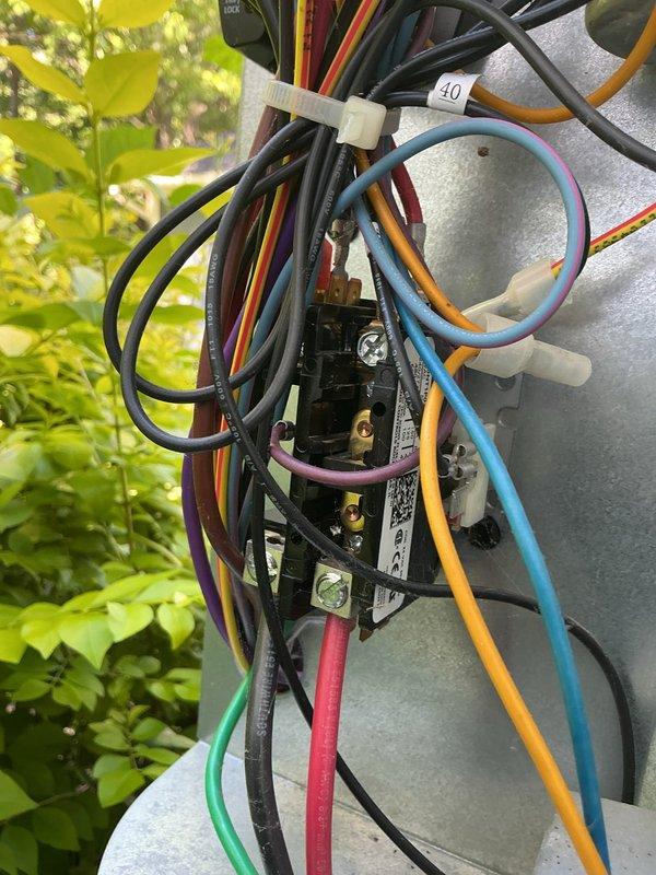 Completed HVAC cooling maintenance tune-up including inspection of outdoor unit electrical connections and testing of system performance. Verified proper airflow and measured supply air temperature at 53°F, confirming adequate cooling operation. All electrical terminations inspected and found secure with proper wire management in place.