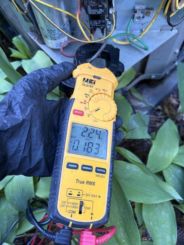 Completed cooling season tune-up on HVAC system. Inspected and tested capacitor functionality, verified proper electrical connections, and measured system amperage readings at 0.183A with 224V supply voltage. All components operating within normal parameters.