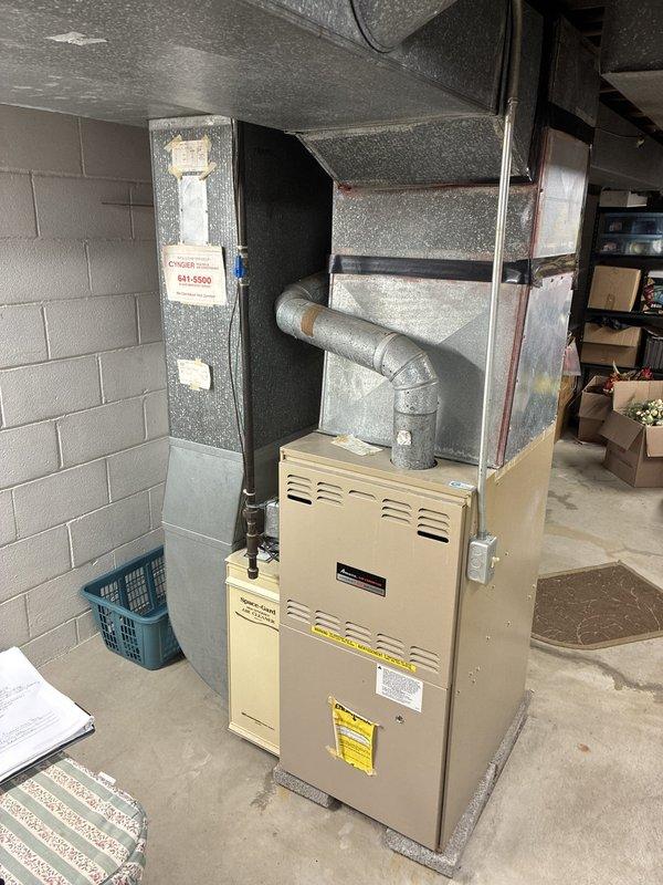 Conducted comprehensive system evaluation for full HVAC replacement estimate on 1994 equipment at residential property managed by third party. Assessed aging outdoor condensing unit showing significant debris accumulation in drain pan and weathering consistent with 30-year service life, along with basement furnace installation featuring standard ductwork configuration. Documented existing system conditions through photographic evidence and provided multiple replacement options to property management for consideration.