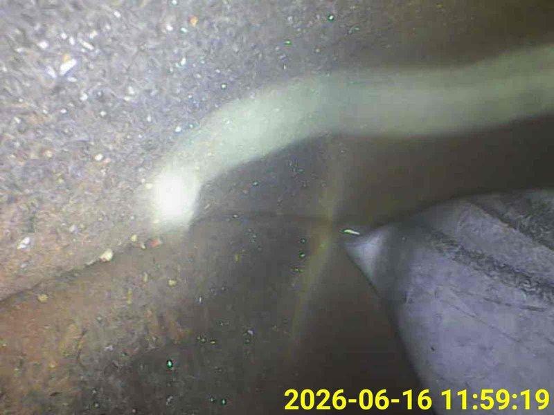 Performed furnace inspection as requested. Conducted internal visual examination of ductwork and heat exchanger components using inspection camera equipment. Identified metallic material, possibly deteriorated foil-backed insulation or detached duct liner, present within the duct system. Documented mineral deposits and residue buildup on interior duct surfaces. System inspection completed and findings photographed for record.
