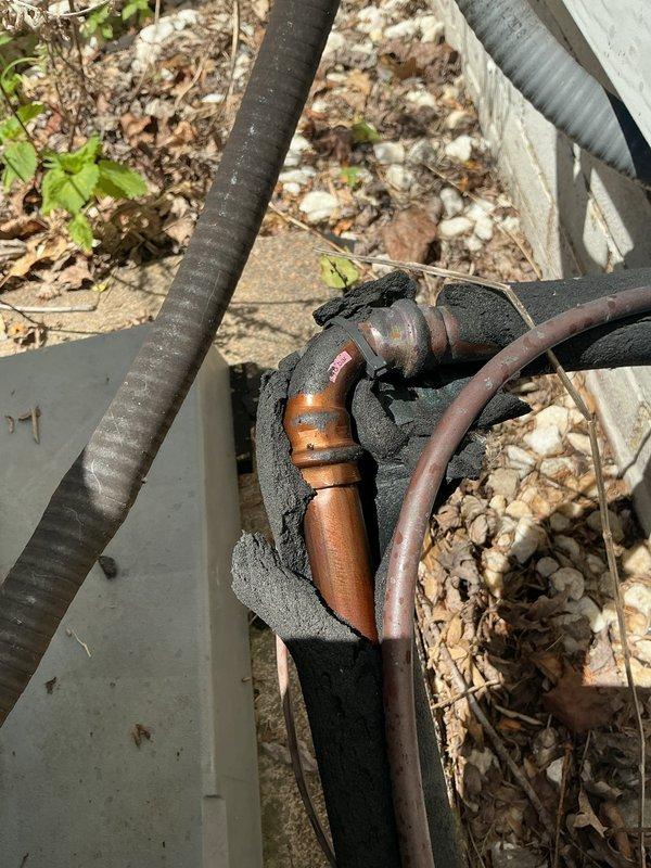 Responded to service call for non-operational cooling system on 7-year-old central air conditioning unit. Upon arrival, performed comprehensive system diagnostics using digital manifold and micron gauge to assess refrigerant pressures, superheat, and subcooling values. Inspection revealed issues with refrigerant levels and system performance parameters. Accessed exterior condensing unit and evaluated refrigerant line set connections at foundation penetration point. Checked integrity of insulated copper line set, noting weathered foam insulation on suction and liquid lines. Measured operating pressures and temperatures to determine root cause of cooling failure. System was successfully restored to proper operating condition with appropriate refrigerant charge and verified all parameters within manufacturer specifications.