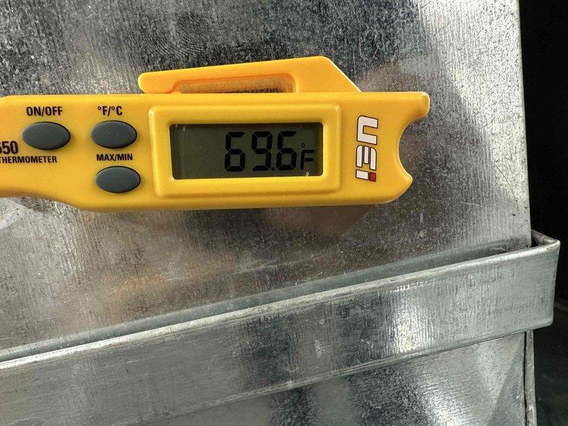 Completed scheduled cooling system maintenance on residential air conditioning unit. Performed comprehensive inspection of outdoor condensing unit, verified electrical parameters using digital multimeter, and measured system temperatures with calibrated digital thermometer recording 69.8°F. All components operating within normal specifications and unit functioning properly for continued cooling season operation.