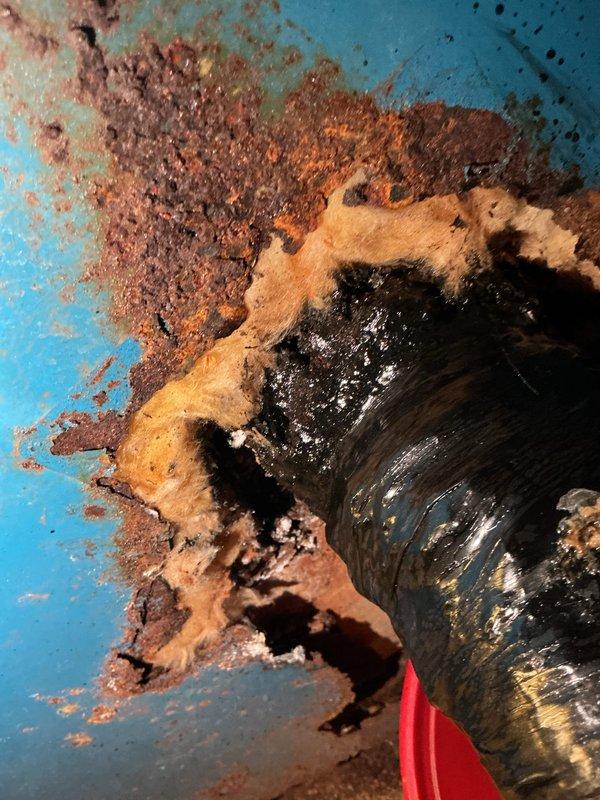 Responded to service call for aging boiler system with reported leak. Upon arrival, conducted thorough inspection and documented extensive corrosion throughout boiler components and associated piping. Found severe rust damage on multiple pipe sections, deteriorated insulation material, and compromised structural integrity of metal surfaces. Corrosion patterns indicated prolonged moisture exposure and age-related deterioration affecting both the unit's piping infrastructure and mounting surfaces. Photographed damaged areas showing flaking rust, peeling protective coatings, and compromised pipe insulation for documentation purposes. Advised customer that the boiler system has reached end of service life and requires replacement due to extensive corrosion and active leak condition presenting safety concerns.