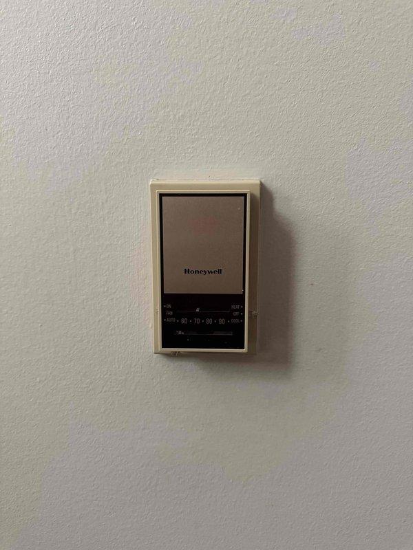 Responded to service call for potential refrigerant leak in residential air conditioning system. Performed comprehensive system inspection of outdoor condenser unit and indoor thermostat controls to identify leak source and assess overall system condition. Documented equipment condition with photographs showing Honeywell thermostat operation and exterior condensing unit installation with refrigerant line routing.