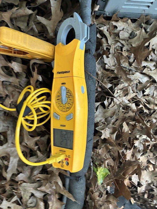 Performed annual preventative maintenance inspection on residential air conditioning system. Conducted comprehensive system evaluation including electrical measurements using clamp meter to verify proper amperage draw and operational efficiency. Inspected condensate drain pan and drainage system, noting active moisture accumulation and debris presence. Verified temperature differential readings at 85.9°F. Examined structural components surrounding unit, observing age-related wear including crack formation in concrete pad. Assessed all accessible mechanical components for proper operation. System operational at time of service completion.