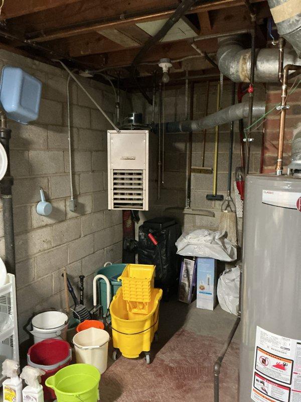 Completed comprehensive HVAC tune-up service on residential split system including both indoor and outdoor components. Performed visual inspection of basement-mounted air handler unit, verified proper operation of heating equipment, and inspected all accessible ductwork and refrigerant line connections. Inspected outdoor condensing unit, documented equipment specifications and serial number, checked electrical connections and capacitors, and verified refrigerant line insulation integrity. All components found operating within normal parameters with no immediate service needs identified.