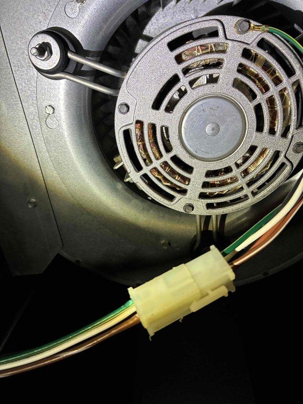 Performed routine cooling system maintenance on HVAC unit. Inspected condenser fan motor assembly, verified proper ventilation through motor housing, and checked electrical connections for security and integrity. Utilized digital clamp meter to measure motor amperage draw at 3.29 amps, confirming operation within manufacturer specifications. All electrical terminals and wire connections were found secure with no signs of overheating or deterioration. Motor assembly showed normal operational wear with adequate airflow through ventilation slots. System operating efficiently with no deficiencies noted.