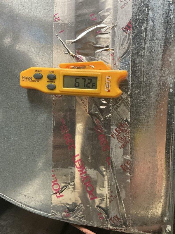 # HVAC Cooling Maintenance Completion

Performed comprehensive preventive maintenance on residential Amana air conditioning system as part of ongoing cooling season service program. Conducted temperature diagnostics at supply ductwork, recording 57.2°F reading using calibrated digital thermometer to verify proper system performance and cooling output. Inspected outdoor condensing unit, confirmed adequate clearance from surrounding landscaping, verified proper airflow through coil fins, and ensured electrical connections and conduit installations remained secure and properly maintained.
