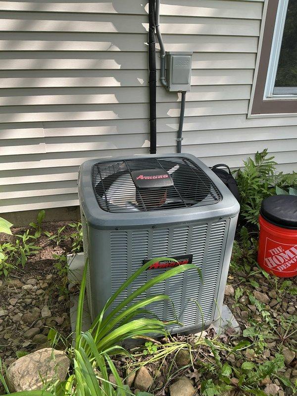 # HVAC Cooling Maintenance Completion

Performed comprehensive preventive maintenance on residential Amana air conditioning system as part of ongoing cooling season service program. Conducted temperature diagnostics at supply ductwork, recording 57.2°F reading using calibrated digital thermometer to verify proper system performance and cooling output. Inspected outdoor condensing unit, confirmed adequate clearance from surrounding landscaping, verified proper airflow through coil fins, and ensured electrical connections and conduit installations remained secure and properly maintained.