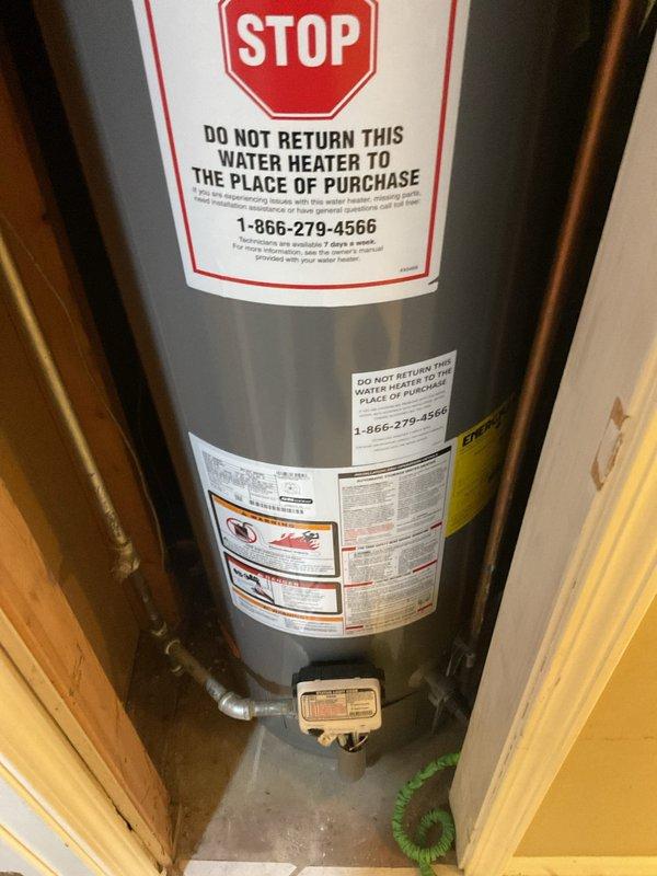 Completed comprehensive HVAC cooling maintenance and water heater flush and fill service as part of ongoing recurring maintenance program. Inspected and serviced residential furnace unit with associated ductwork, noting condensation present on metallic ductwork elbow near base of unit. Performed complete water heater flush and fill procedure on residential tank-style water heater, ensuring proper operation of all components and controls.