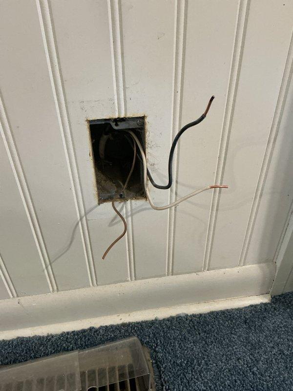 Responded to electrical service call for outlet and blown fuse issue. Upon inspection, found exposed electrical wiring extending from wall opening with multiple conductors and wire nut connections visible, indicating incomplete or damaged outlet installation. Assessed electrical connections, verified proper wire routing, and restored safe electrical service to the affected circuit.