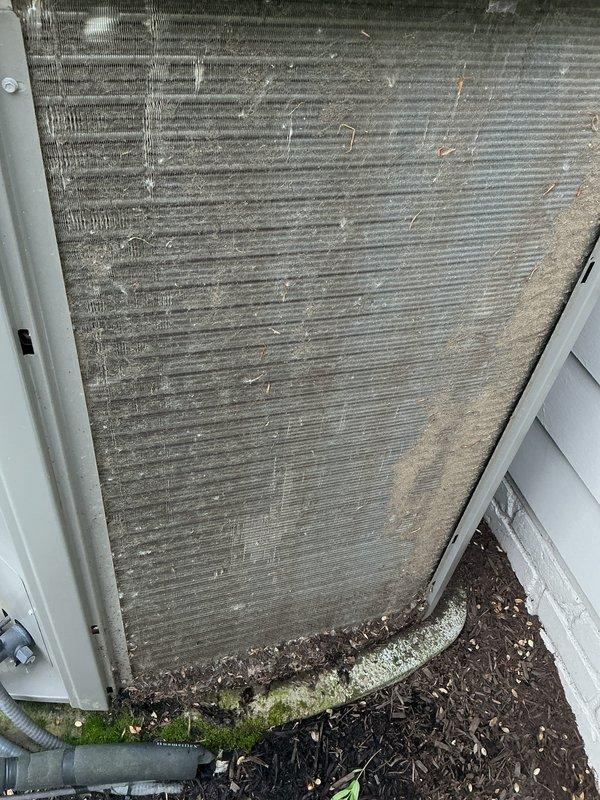 Returned to complete service on outdoor condensing unit that exhibited significant debris accumulation and deteriorated capacitor. Performed thorough coil wash to remove heavy buildup of dirt, organic matter, and debris that had collected along the lower coil sections and fins, which was restricting airflow and reducing system efficiency. Replaced failed capacitor to restore proper compressor and fan motor operation. Unit tested and confirmed operating within normal parameters upon completion.