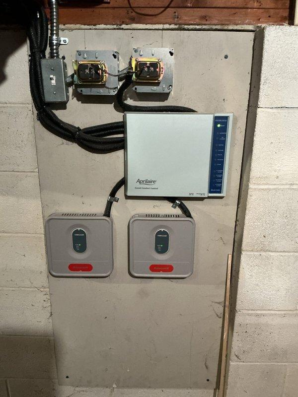 Completed scheduled cooling maintenance on residential HVAC system. Performed standard tune-up procedures including inspection of furnace unit, electrical connections, Aprilaire humidifier control, and associated components. All equipment found operating within normal parameters with proper ventilation and drainage systems intact.