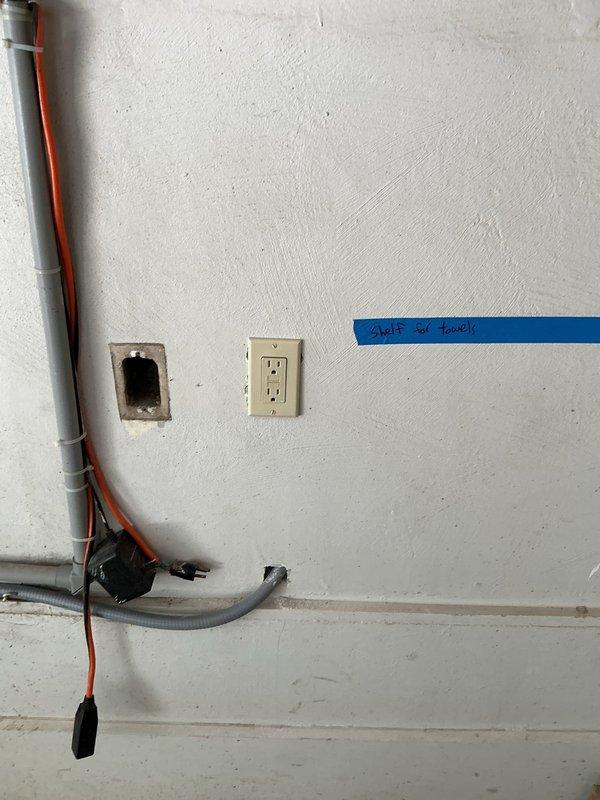 Completed warranty service for previous rewire installation. Addressed electrical outlet concerns, verified conduit routing and connections, and ensured all junction boxes and receptacles were properly secured and functioning. Documented existing conditions including plumbing infrastructure proximity and wall penetrations for quality assurance records.