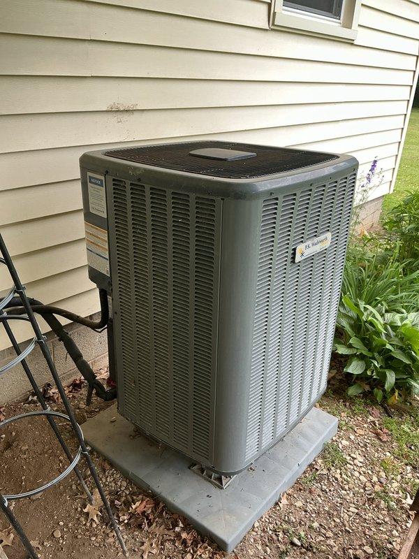 # HVAC Cooling Maintenance Summary

Completed scheduled preventive maintenance on residential air conditioning system. Performed comprehensive inspection of outdoor condenser unit, confirming proper operation and adequate clearance from surrounding vegetation. Documented supply air temperature readings at ductwork, measuring 122.3°F, indicating normal system operation under cooling mode. Unit showed typical outdoor weathering with no signs of damage or deterioration. All components functioning within manufacturer specifications.

# Detailed Service Report

Performed routine preventive maintenance inspection on residential split-system air conditioning unit as part of ongoing maintenance agreement. Conducted thorough visual assessment of outdoor condenser unit positioned on concrete pad along exterior wall. Verified unit clearances meet manufacturer requirements, noting vegetation growth on right side but maintaining adequate airflow to equipment. Condenser cabinet showed normal weather