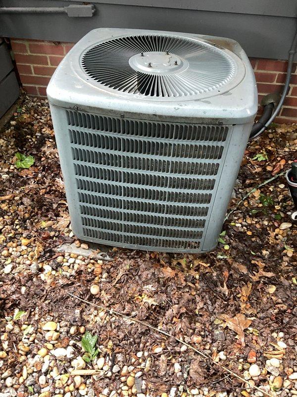 Completed comprehensive cooling system maintenance on aging outdoor air conditioning condenser unit showing signs of weathering and outdoor exposure. Performed standard preventive maintenance procedures including inspection of all components, cleaning of condenser coils and exterior surfaces, verification of refrigerant levels, and assessment of electrical connections and controls to ensure continued reliable operation of the 10+ year old system.