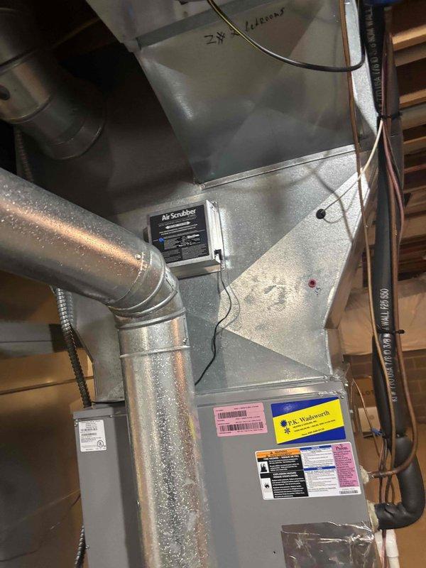 Returned to complete service call to replace two UV bulbs in the air purification system and finish cleaning of outdoor condensing units. Replaced bulbs in the AI Scrubber unit mounted on the indoor air handler, verified proper operation of the air purification system, and completed thorough cleaning of both outdoor AC units including coil cleaning and debris removal from the equipment pad area.