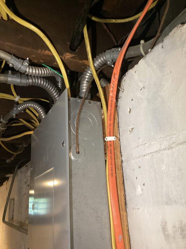 Conducted comprehensive electrical inspection of residential utility space and storage area. Evaluated electrical panel, conduit installations, and wire routing systems for code compliance and safety standards. Documented existing conditions including metallic flexible conduits, multi-circuit wiring configurations, and junction box connections. Photographed electrical infrastructure showing proper conduit entry points and wire management throughout mechanical room. Verified structural mounting of electrical components and assessed overall system integrity.