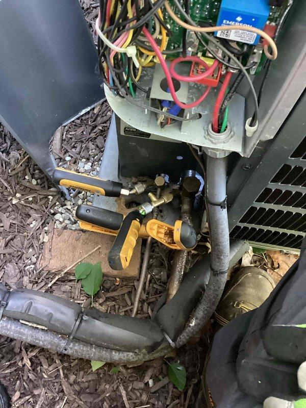 Performed comprehensive cooling season tune-up on outdoor condensing unit, including refrigerant pressure readings documentation with manifold gauges on service ports, electrical connections inspection at control board, and condenser coil assessment. Unit operating within normal parameters with coils clean and all components functioning properly; readings collected and recorded for comparison with previous maintenance data.