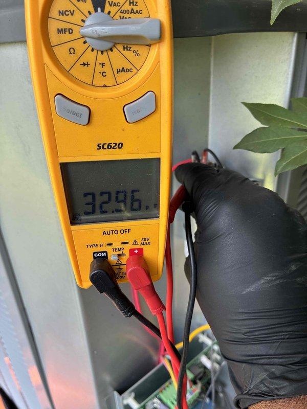 Completed cooling system tune-up on residential HVAC unit, including filter inspection and electrical diagnostics. Measured system amperage at 32.96 amps using clamp meter to verify compressor performance and confirm unit operating within normal parameters. All components functioning properly with no issues identified.