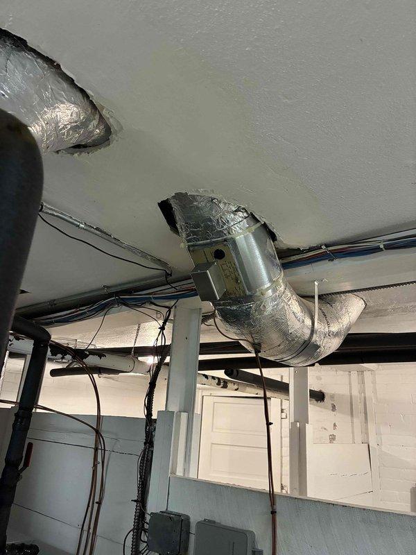 Responded to customer concern regarding wall damage potentially related to AC system. Performed visual inspection of ceiling-mounted HVAC installation including air handler unit, ductwork, and refrigerant line insulation. Documented existing conditions of reflective duct insulation, foam-wrapped refrigerant lines, and connections between air handling unit and distribution ductwork. All components appear to be in normal working condition with no visible signs of active leaks or condensation issues that would cause wall moisture damage.