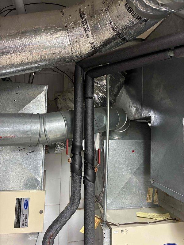 Responded to customer concern regarding wall damage potentially related to AC system. Performed visual inspection of ceiling-mounted HVAC installation including air handler unit, ductwork, and refrigerant line insulation. Documented existing conditions of reflective duct insulation, foam-wrapped refrigerant lines, and connections between air handling unit and distribution ductwork. All components appear to be in normal working condition with no visible signs of active leaks or condensation issues that would cause wall moisture damage.