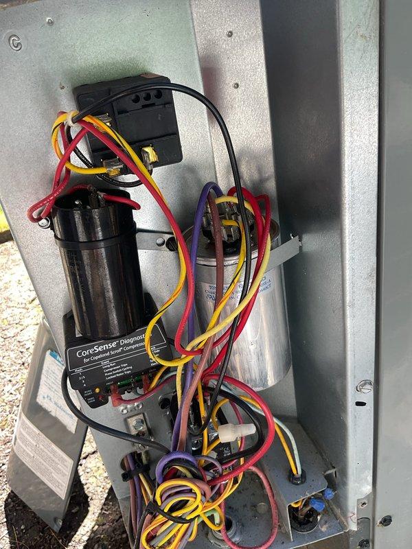 Completed comprehensive cooling system maintenance on residential HVAC unit. Performed thorough inspection of outdoor condensing unit's electrical compartment, verifying proper operation of CoreSense Diagnostic module and all associated wiring connections. Inspected indoor air handler, checked air filter condition, and confirmed proper airflow through the system. All components found operating within normal parameters with no issues identified.