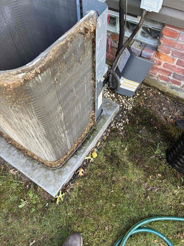 Performed thorough cleaning of heavily soiled condenser coil and blower wheel on residential HVAC system. The condenser coil exhibited significant accumulation of dirt, debris, and organic matter that was restricting airflow and reducing system efficiency. Cleaned all components to restore proper operation and provided quote for hot water tank relief valve replacement.