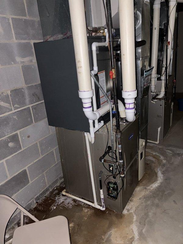 Completed installation of new air conditioning system in basement mechanical room. System installed alongside existing furnace unit with proper electrical connections, PVC condensate drainage piping, and metal ductwork integration. All equipment tested and operational upon completion, with balance collected from customer.