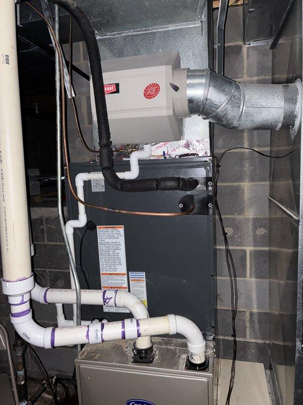 Completed installation of new air conditioning system in basement mechanical room. System installed alongside existing furnace unit with proper electrical connections, PVC condensate drainage piping, and metal ductwork integration. All equipment tested and operational upon completion, with balance collected from customer.