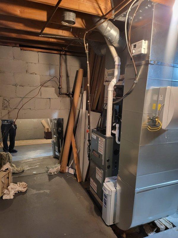Completed full HVAC system installation including two high-efficiency furnace and air conditioning units achieving 96% AFUE rating. Installed surge protection devices on both systems to safeguard equipment from electrical damage. Configured air conditioning units with side discharge configuration for optimal airflow and space utilization in basement mechanical room. All ductwork connections properly sealed and secured, with flexible ducting routed to existing distribution system. Electrical connections completed to code with appropriate disconnects and overcurrent protection. System startup performed on both units with verification of proper airflow, refrigerant charge, and combustion efficiency. Customer provided instruction on thermostat operation and system maintenance requirements.