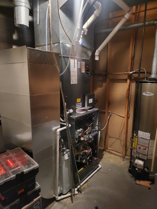 Completed full HVAC system installation including two high-efficiency furnace and air conditioning units achieving 96% AFUE rating. Installed surge protection devices on both systems to safeguard equipment from electrical damage. Configured air conditioning units with side discharge configuration for optimal airflow and space utilization in basement mechanical room. All ductwork connections properly sealed and secured, with flexible ducting routed to existing distribution system. Electrical connections completed to code with appropriate disconnects and overcurrent protection. System startup performed on both units with verification of proper airflow, refrigerant charge, and combustion efficiency. Customer provided instruction on thermostat operation and system maintenance requirements.