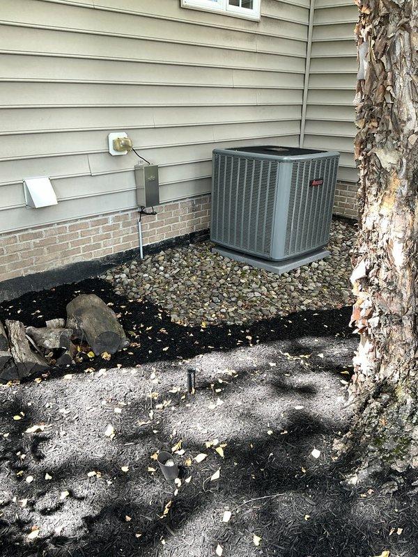 Conducted on-site evaluation for residential HVAC system replacement. Assessed existing outdoor condensing unit positioned on gravel pad adjacent to structure with light green vinyl siding. Documented current equipment configuration including electrical connections, conduit routing, and mounting location. Photographed existing split-system air conditioning unit to provide replacement options and specifications for customer consideration. Equipment evaluation complete, awaiting customer decision on replacement system selection.