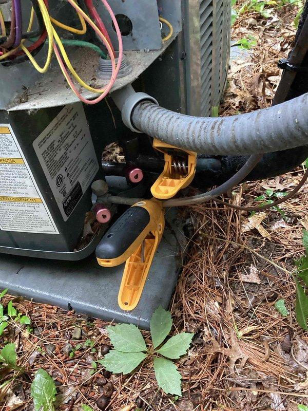 Completed routine cooling season preventive maintenance on residential air conditioning system. Inspected outdoor condensing unit, verified proper refrigerant line connections and mounting hardware, and documented operational temperatures with infrared thermometer reading 64.7°F at indoor evaporator coil. All system components found operating within normal parameters with no deficiencies noted.