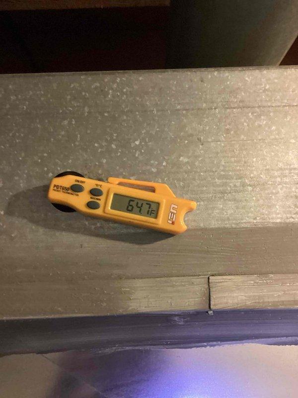 Completed routine cooling season preventive maintenance on residential air conditioning system. Inspected outdoor condensing unit, verified proper refrigerant line connections and mounting hardware, and documented operational temperatures with infrared thermometer reading 64.7°F at indoor evaporator coil. All system components found operating within normal parameters with no deficiencies noted.