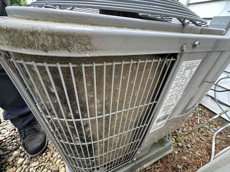 Completed scheduled cooling system maintenance on residential outdoor condensing unit. Performed comprehensive inspection of condenser assembly, verified protective grille cage integrity, checked electrical disconnect box and associated wiring connections, and examined refrigerant line routing. Unit showed normal weathering and environmental debris accumulation consistent with outdoor exposure. All components found to be operational and functioning within normal parameters.