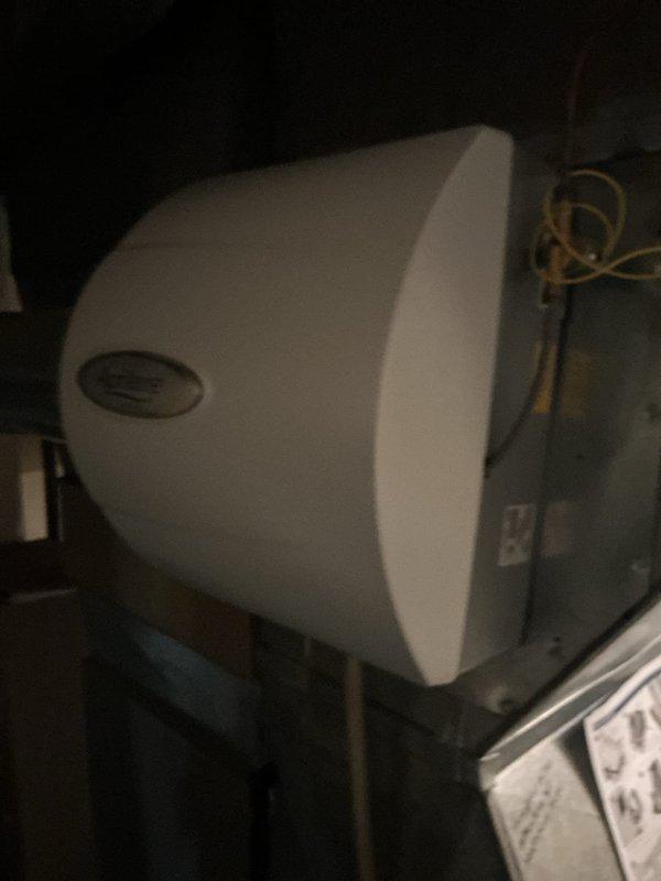 Responded to service call for air conditioning unit not cooling. Upon inspection, found outdoor condenser unit showing significant age and weathering with visible rust on fan grille and algae growth on exterior panels. Performed diagnostic assessment of both outdoor condenser and indoor air handler components to identify cooling system failure.