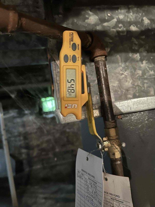 Completed routine cooling season tune-up on residential HVAC system. Measured and recorded suction line temperature at 54°F, inspected electrical connections and capacitor wiring at outdoor condensing unit, and removed accumulated debris including leaves and grass clippings from equipment base to ensure proper airflow and system operation.