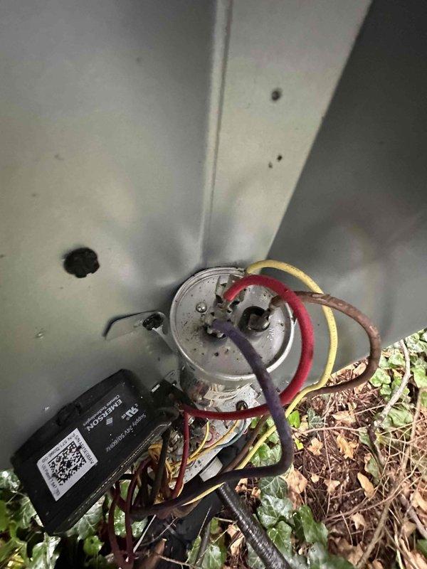 Completed routine cooling season tune-up on residential HVAC system. Measured and recorded suction line temperature at 54°F, inspected electrical connections and capacitor wiring at outdoor condensing unit, and removed accumulated debris including leaves and grass clippings from equipment base to ensure proper airflow and system operation.