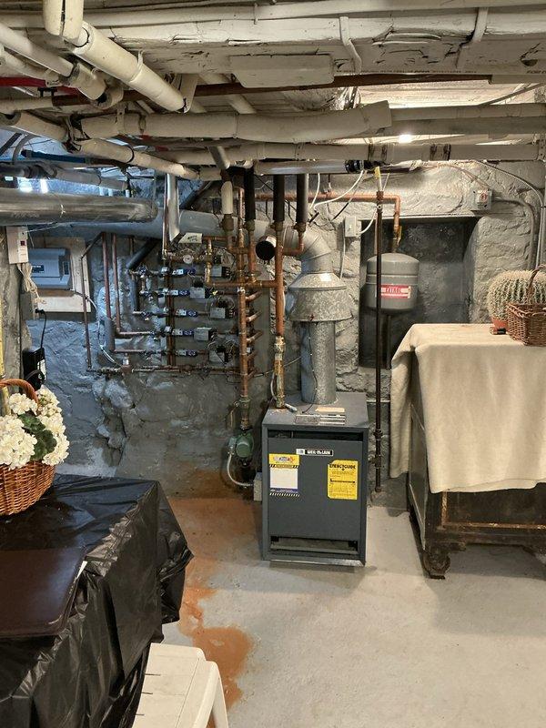 Conducted on-site assessment and provided estimate for replacement of 30-year-old boiler system that has failed and is no longer operational. Evaluated existing heating infrastructure including copper piping, manifold connections, and associated plumbing components in basement utility area. Documented current equipment configuration with water heater, expansion tank, and distribution system to ensure accurate replacement specifications and proper sizing for new boiler installation.