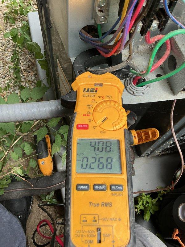 Completed cooling tune-up on residential HVAC system. Performed temperature diagnostics on evaporator coil, recording supply air temperature of 65.8°F. Conducted electrical measurements at outdoor condensing unit, verifying system amperage and voltage readings. Noted heavy dust and debris accumulation on evaporator coil fins requiring future cleaning to maintain optimal airflow and efficiency.